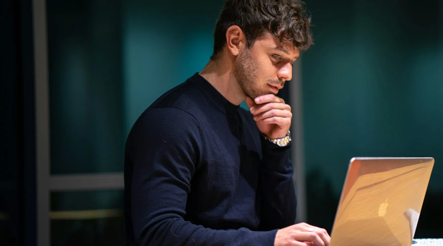 Man staring at laptop screen concerned about online privacy